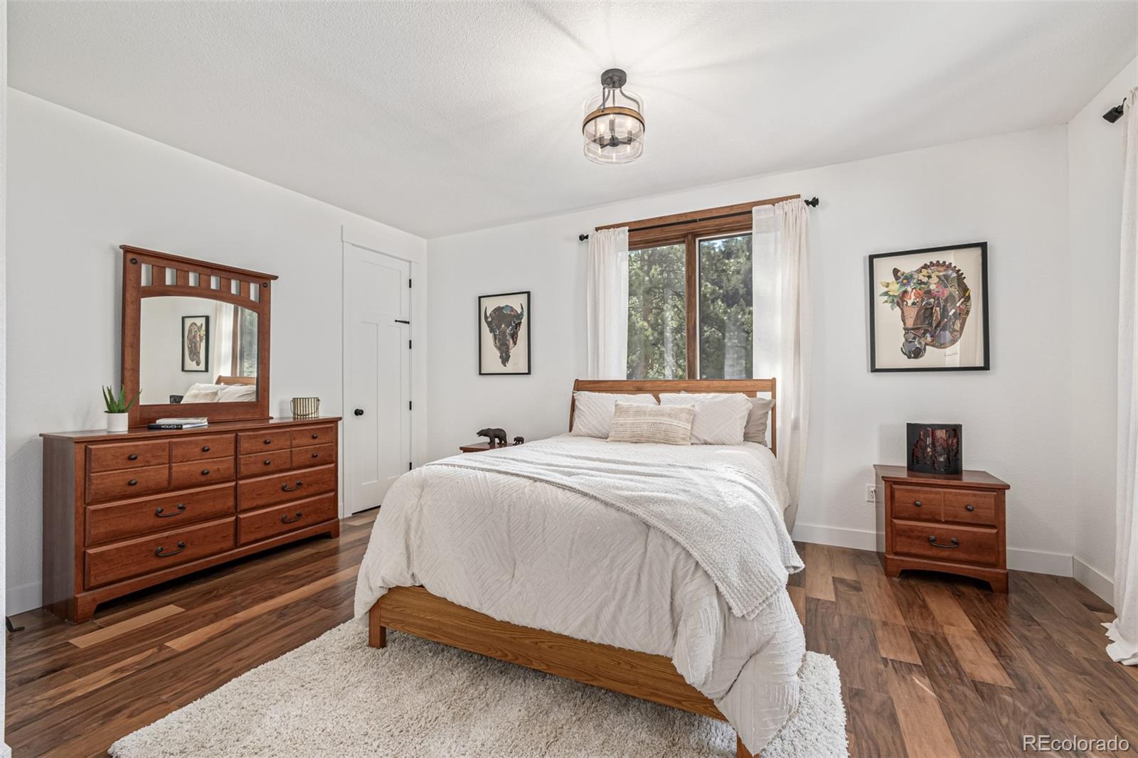 663 Brookside Drive Bailey, CO 80421 - Photo 26 of 47 a bedroom with a bed and a dresser in it