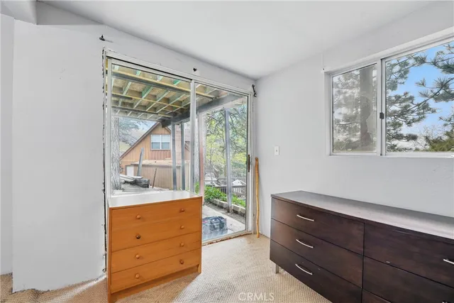 a room with a dresser and a window