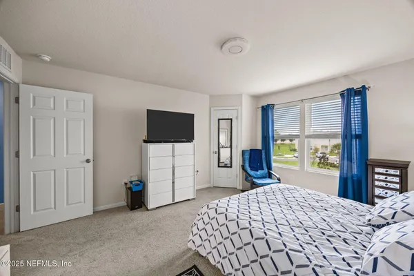 a bedroom with a bed and a desk