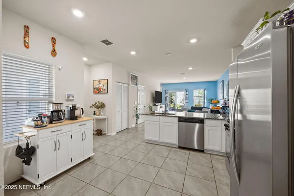a view of a kitchen with a sink and refrigerator