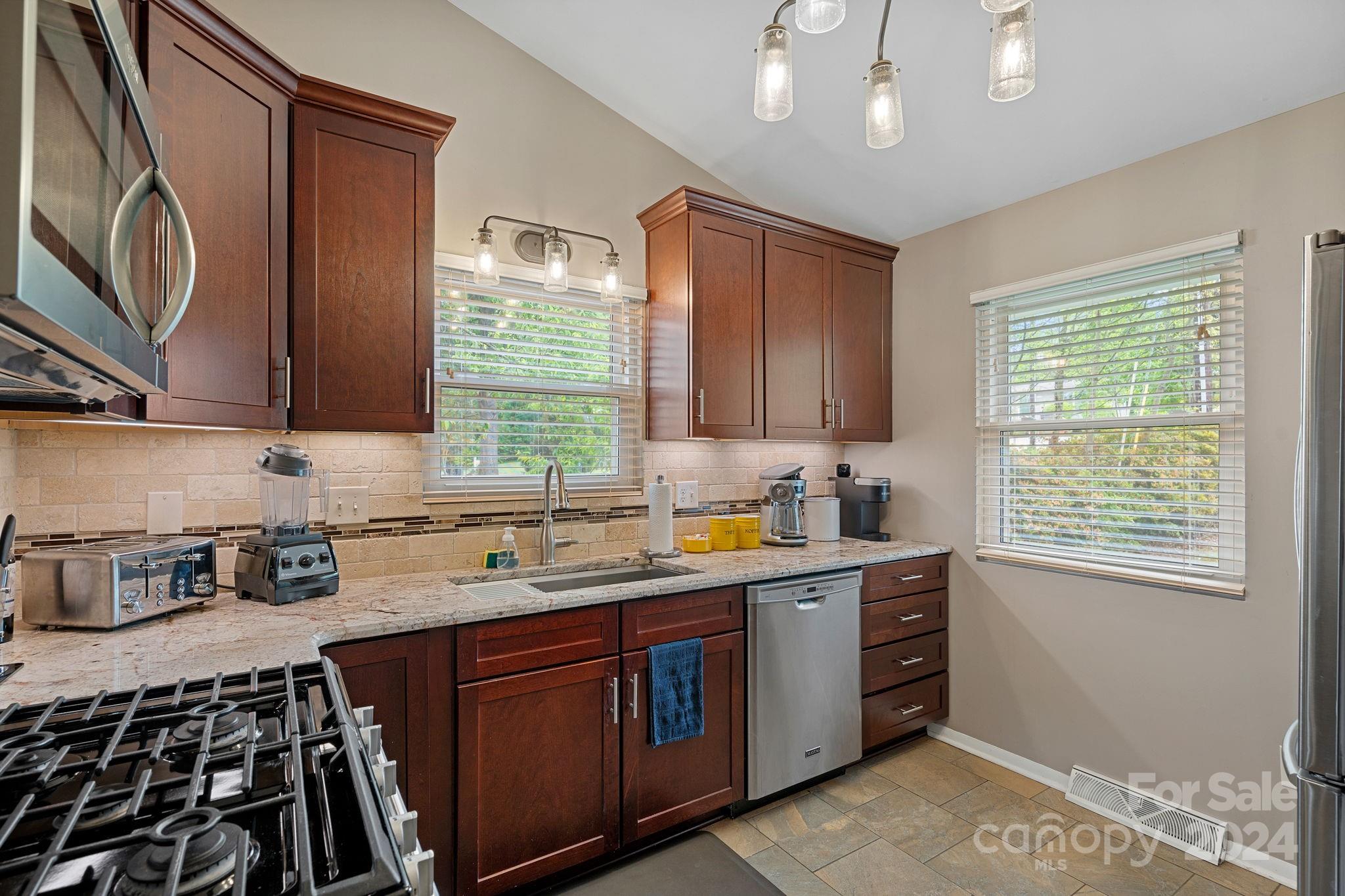 21212 Rio Oro Drive Cornelius, NC 28031 - Photo 13 of 41 a kitchen with a sink stove and cabinets