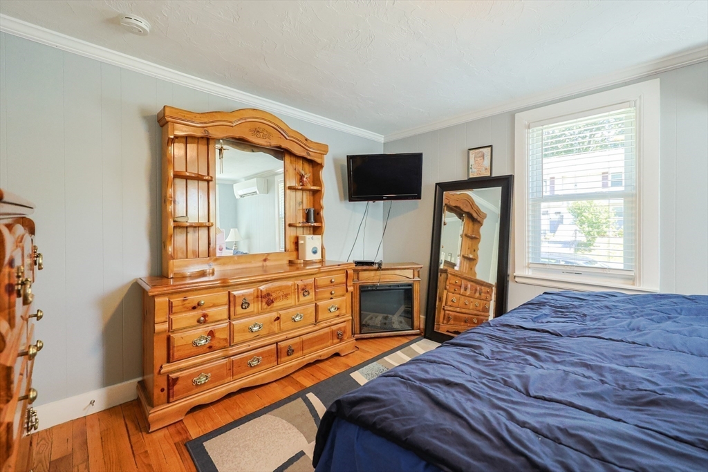 23 Superior Road Worcester, MA 01604 - Photo 18 of 32 a bedroom with a bed and a flat tv screen on the dresser