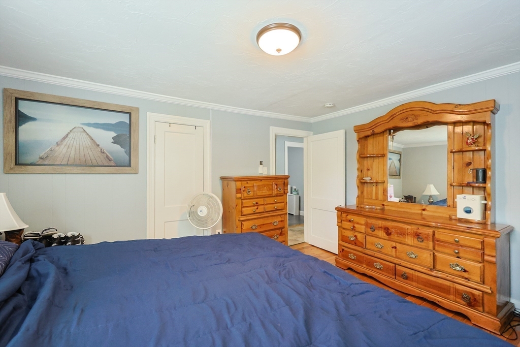 23 Superior Road Worcester, MA 01604 - Photo 20 of 32 a bedroom with a bed and wooden floor