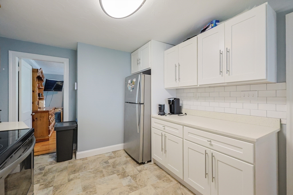 23 Superior Road Worcester, MA 01604 - Photo 22 of 32 a kitchen with white cabinets and refrigerator
