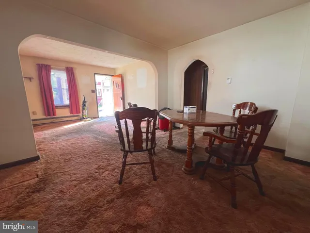 a dining room with furniture and window