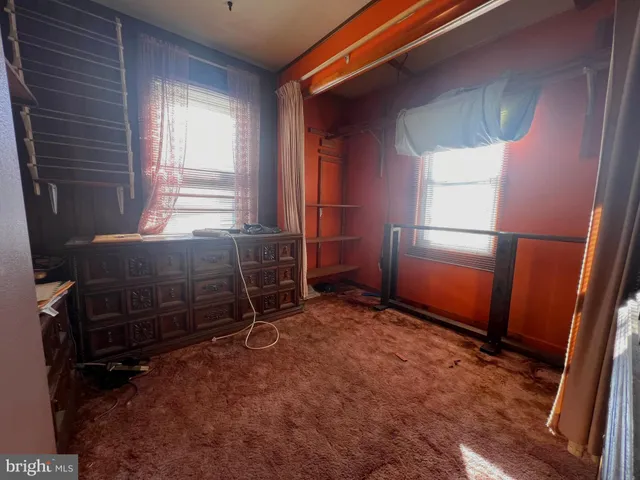 a view of a hallway with wooden shelves