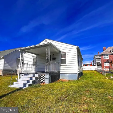 a view of a house with a backyard porch and sitting area