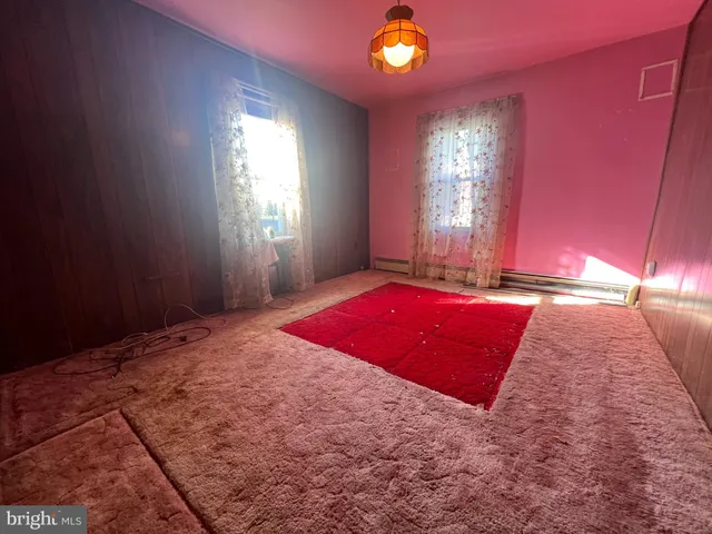 a view of a livingroom with furniture and chandelier fan