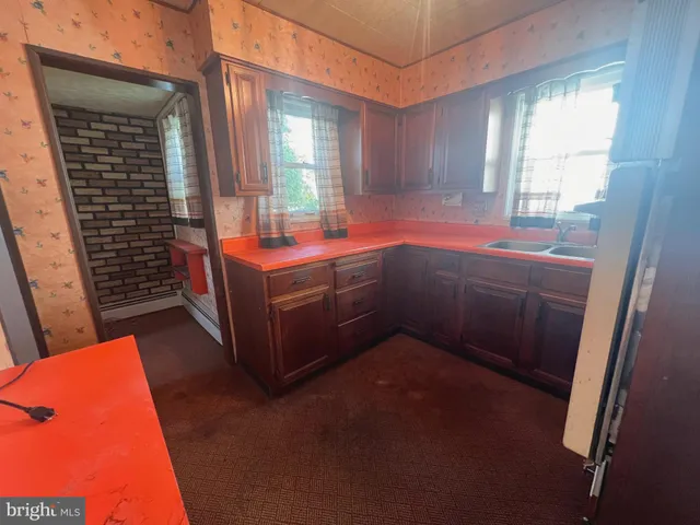 a kitchen with a sink a stove and cabinets