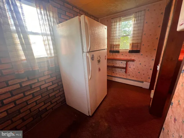 a view of a livingroom with furniture and a window