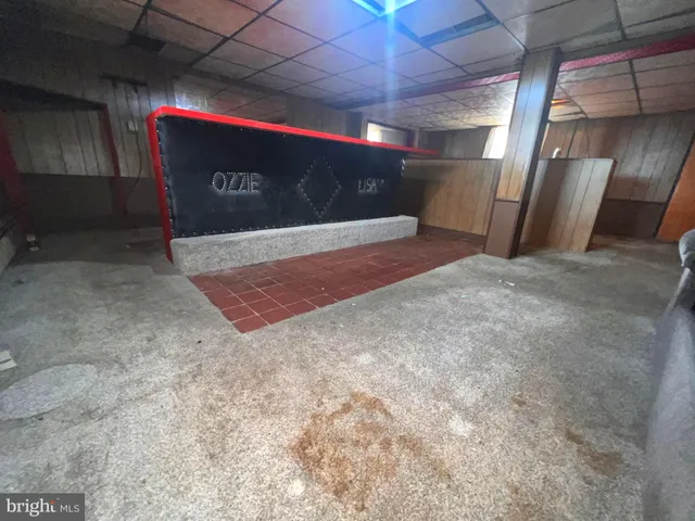 a view of a house with a yard patio and fire pit