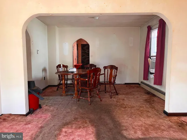 a view of a dining room with furniture and window