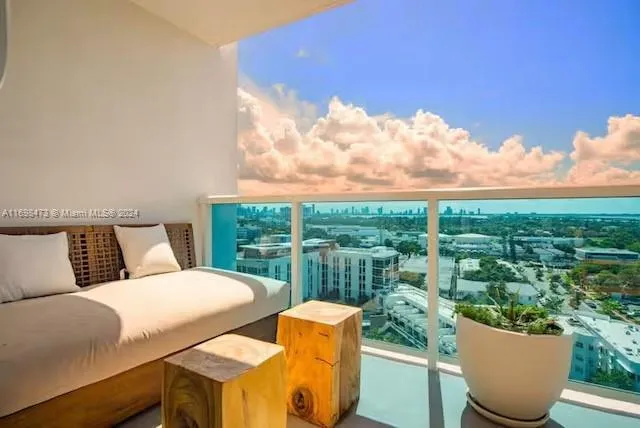 a view of a balcony with couches and wooden floor