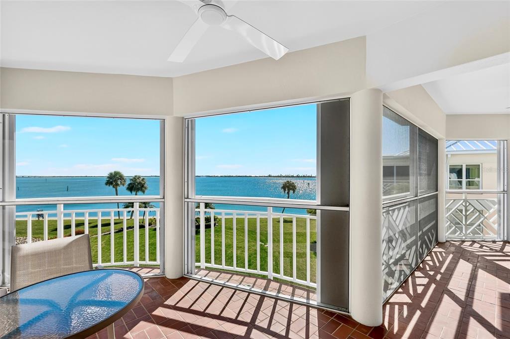 11000 Placida Road, Unit 2804 Placida, FL 33946 - Photo 11 of 56 a view of a city from a balcony filled with furniture
