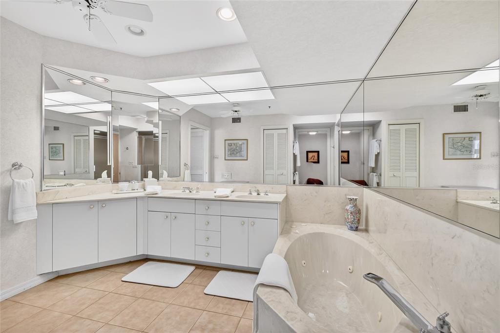 11000 Placida Road, Unit 2804 Placida, FL 33946 - Photo 16 of 56 a bathroom with a sink mirror and a bathtub