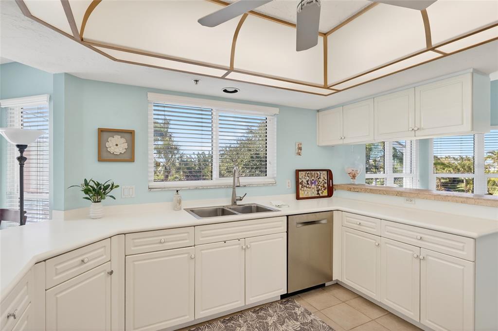 11000 Placida Road, Unit 2804 Placida, FL 33946 - Photo 19 of 56 a kitchen with white cabinets and window