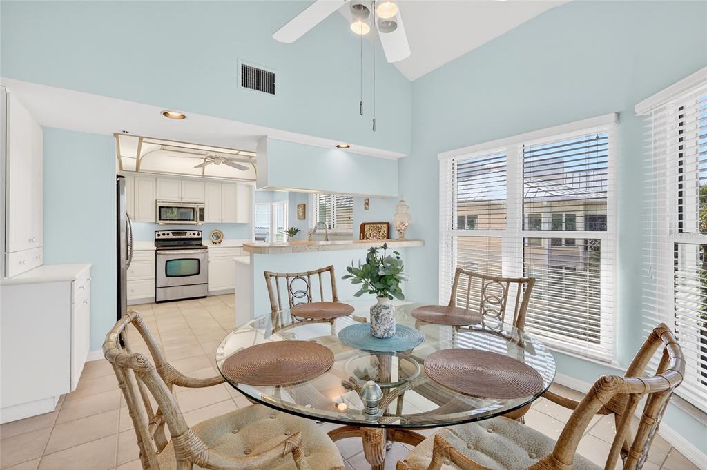 11000 Placida Road, Unit 2804 Placida, FL 33946 - Photo 21 of 56 a dining room with furniture a kitchen and chandelier