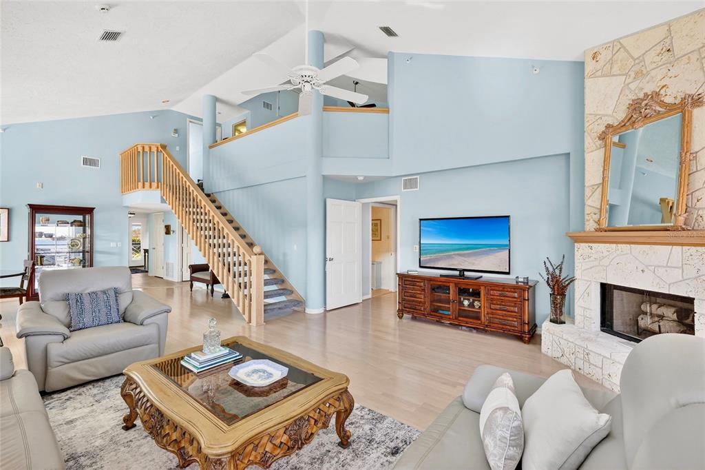 11000 Placida Road, Unit 2804 Placida, FL 33946 - Photo 8 of 56 a living room with furniture a fireplace and a flat screen tv