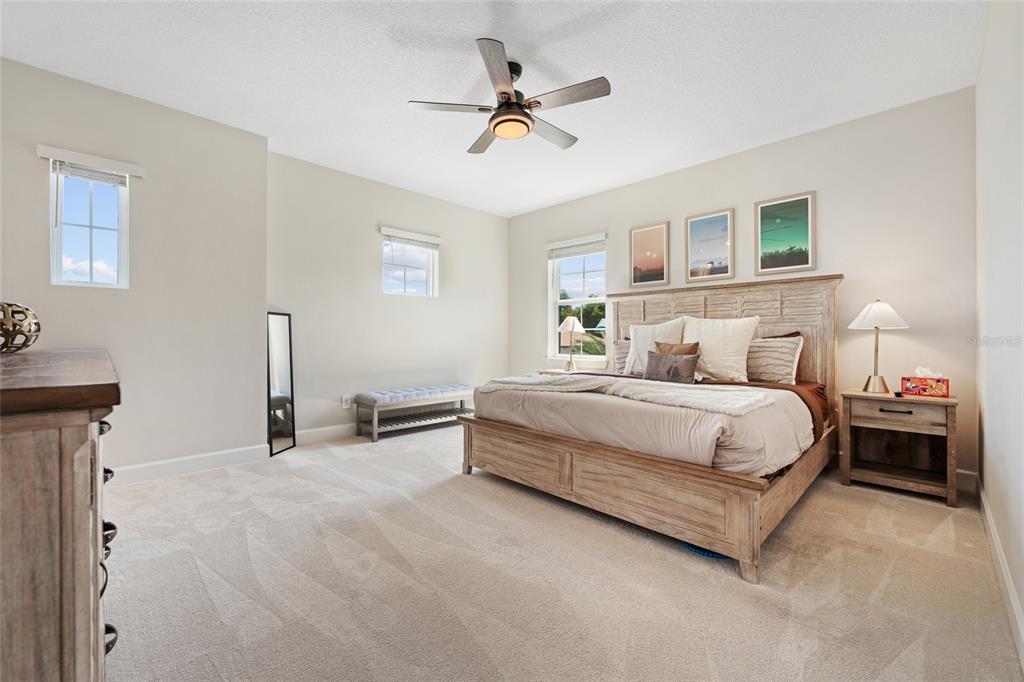 10175 Brocksport Circle Gotha, FL 34734 - Photo 41 of 54 a bedroom with bed and a chandelier