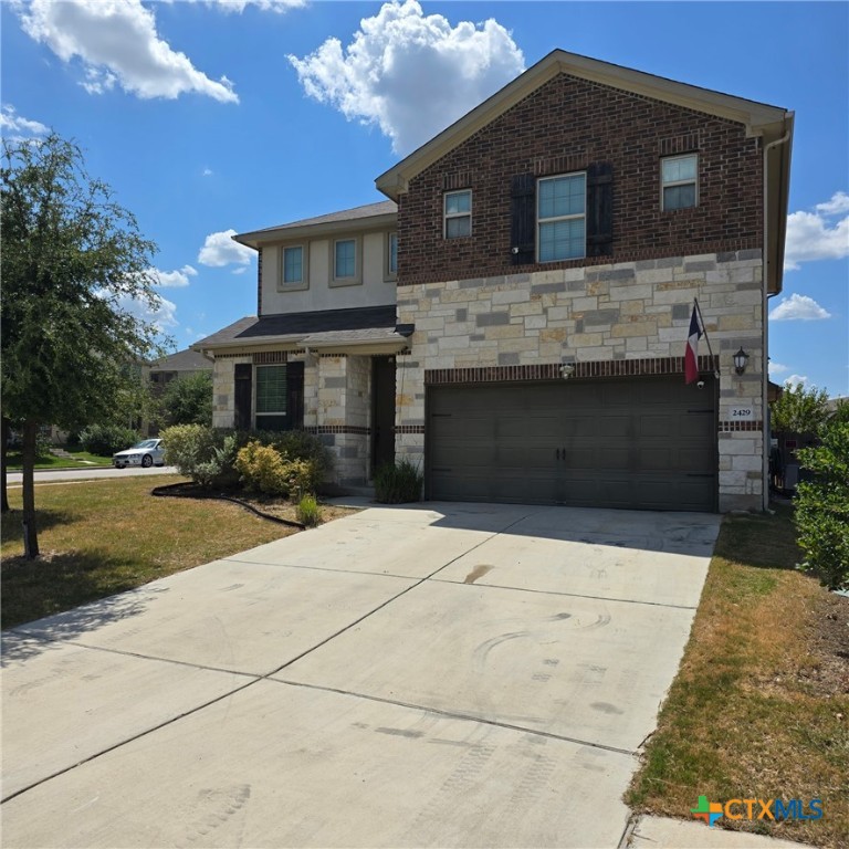 a front view of a house with yard