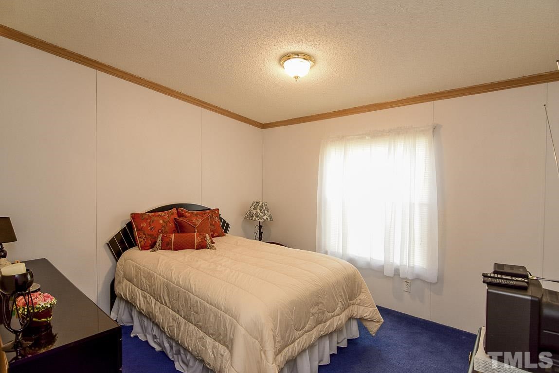 10129 Smith Road Middlesex, NC 27557 - Photo 18 of 25 a bedroom with a bed and a window
