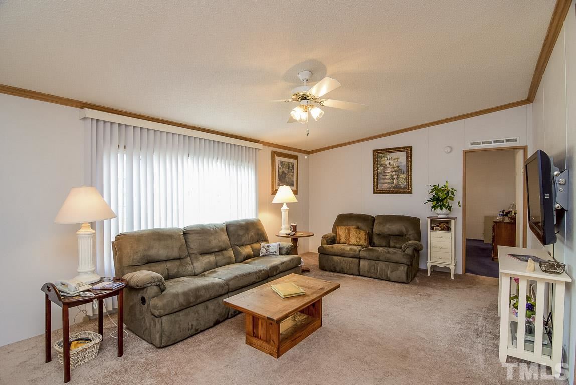 10129 Smith Road Middlesex, NC 27557 - Photo 21 of 25 a living room with furniture a ceiling fan and a window