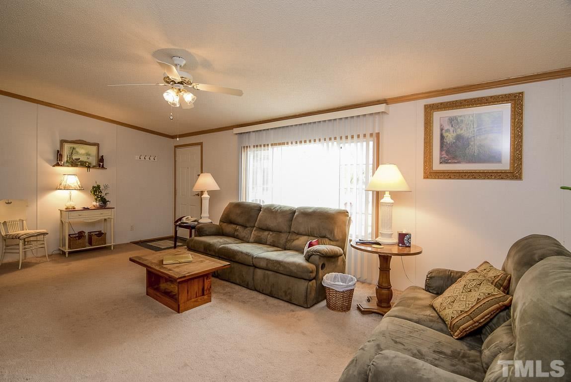 10129 Smith Road Middlesex, NC 27557 - Photo 22 of 25 a living room with furniture and a lamp