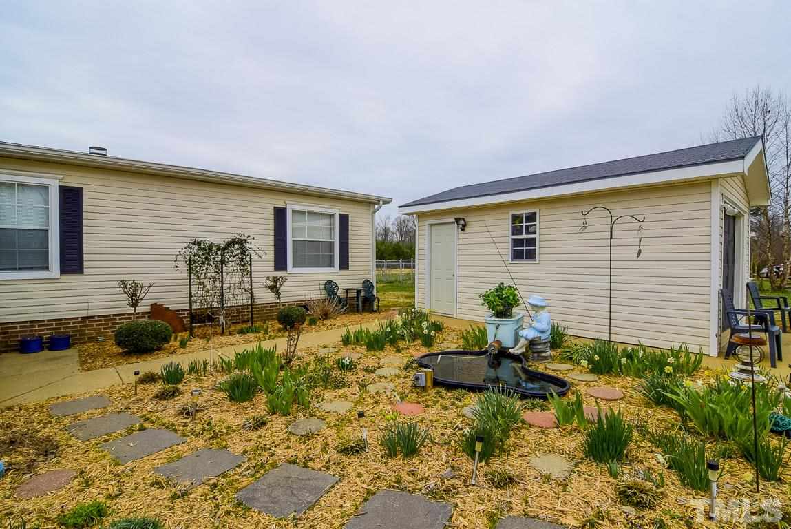10129 Smith Road Middlesex, NC 27557 - Photo 5 of 25 a backyard of a house with garden and patio
