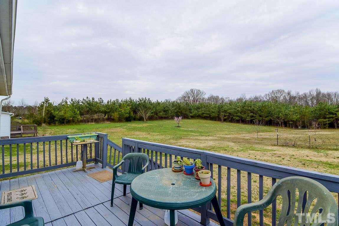 10129 Smith Road Middlesex, NC 27557 - Photo 10 of 25 a view of a deck with two chairs and a table
