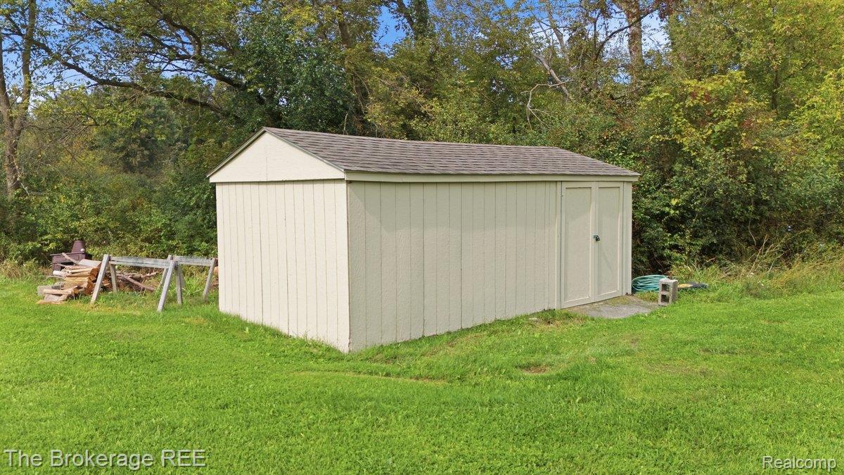 2422 South Henderson Road Davison, MI 48423 - Photo 49 of 53 Gable roof storage shed featuring vertical siding and double doors