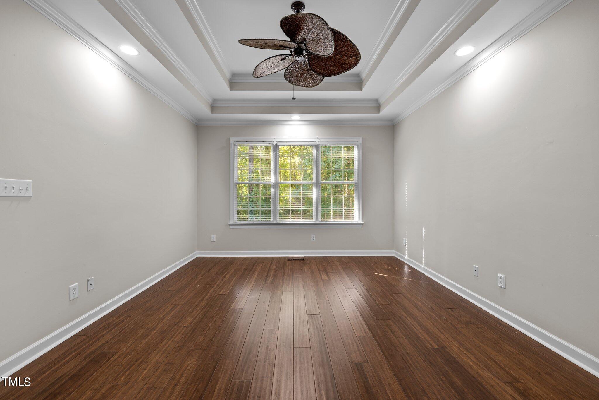 7621 Wilderness Road Raleigh, NC 27613 - Photo 23 of 60 wooden floor in an empty room with a window