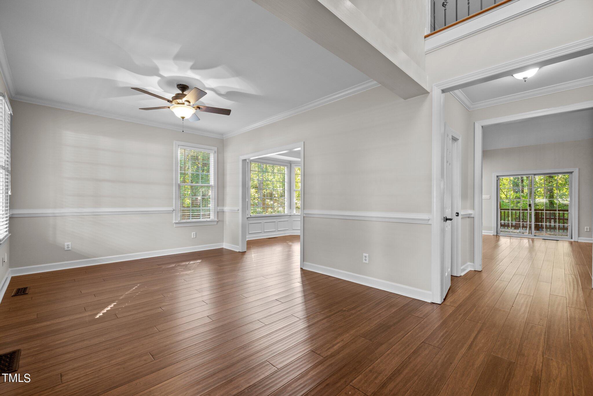 7621 Wilderness Road Raleigh, NC 27613 - Photo 3 of 60 an empty room with wooden floor and windows