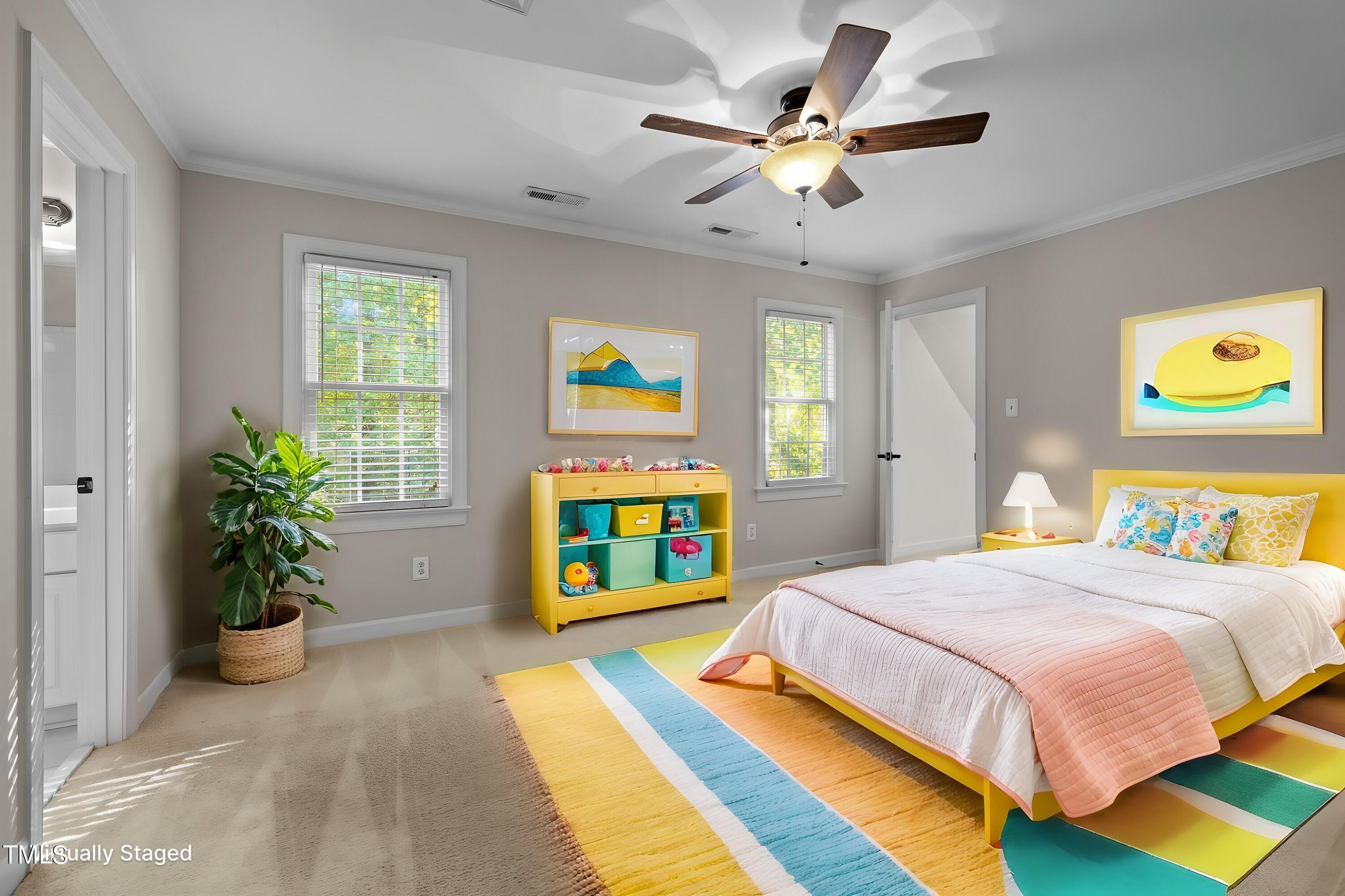 7621 Wilderness Road Raleigh, NC 27613 - Photo 34 of 60 a bedroom with a bed and a chandelier