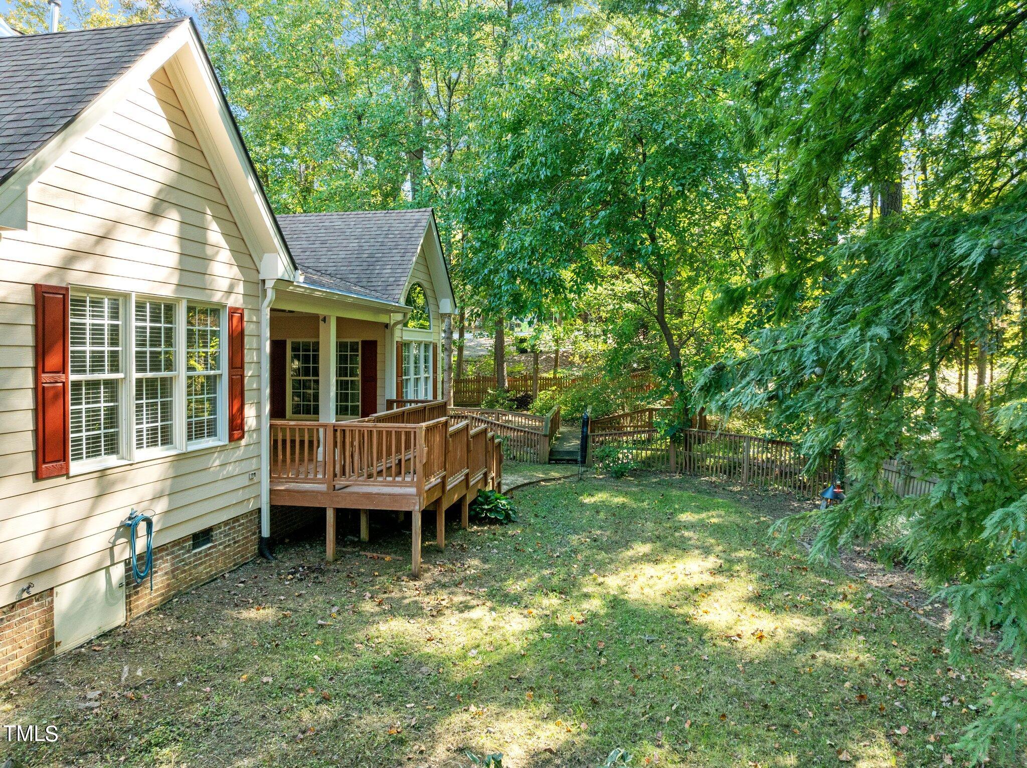 7621 Wilderness Road Raleigh, NC 27613 - Photo 56 of 60 a backyard of a house with table and chairs