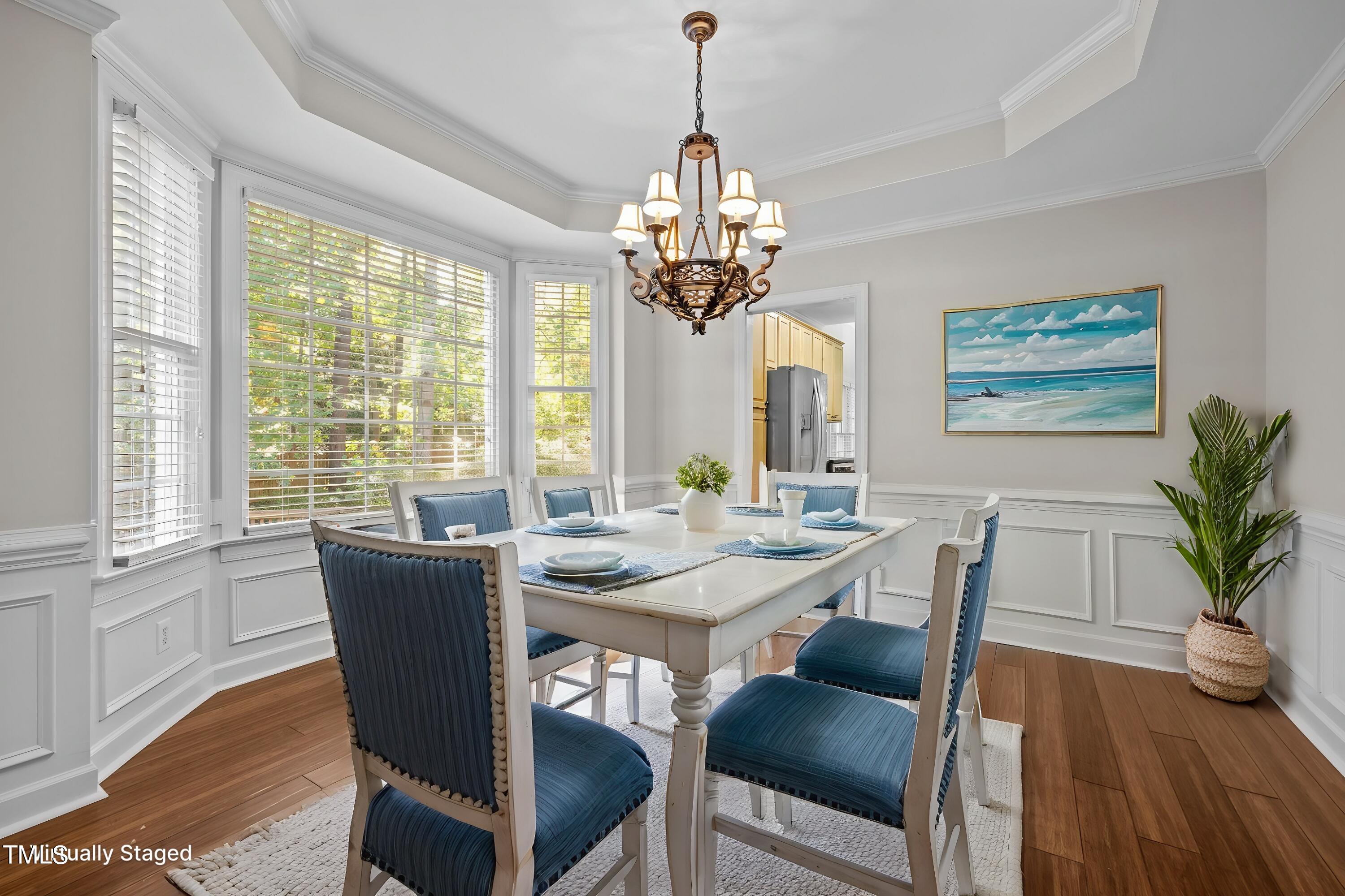 7621 Wilderness Road Raleigh, NC 27613 - Photo 7 of 60 a view of a dining room with furniture window and wooden floor