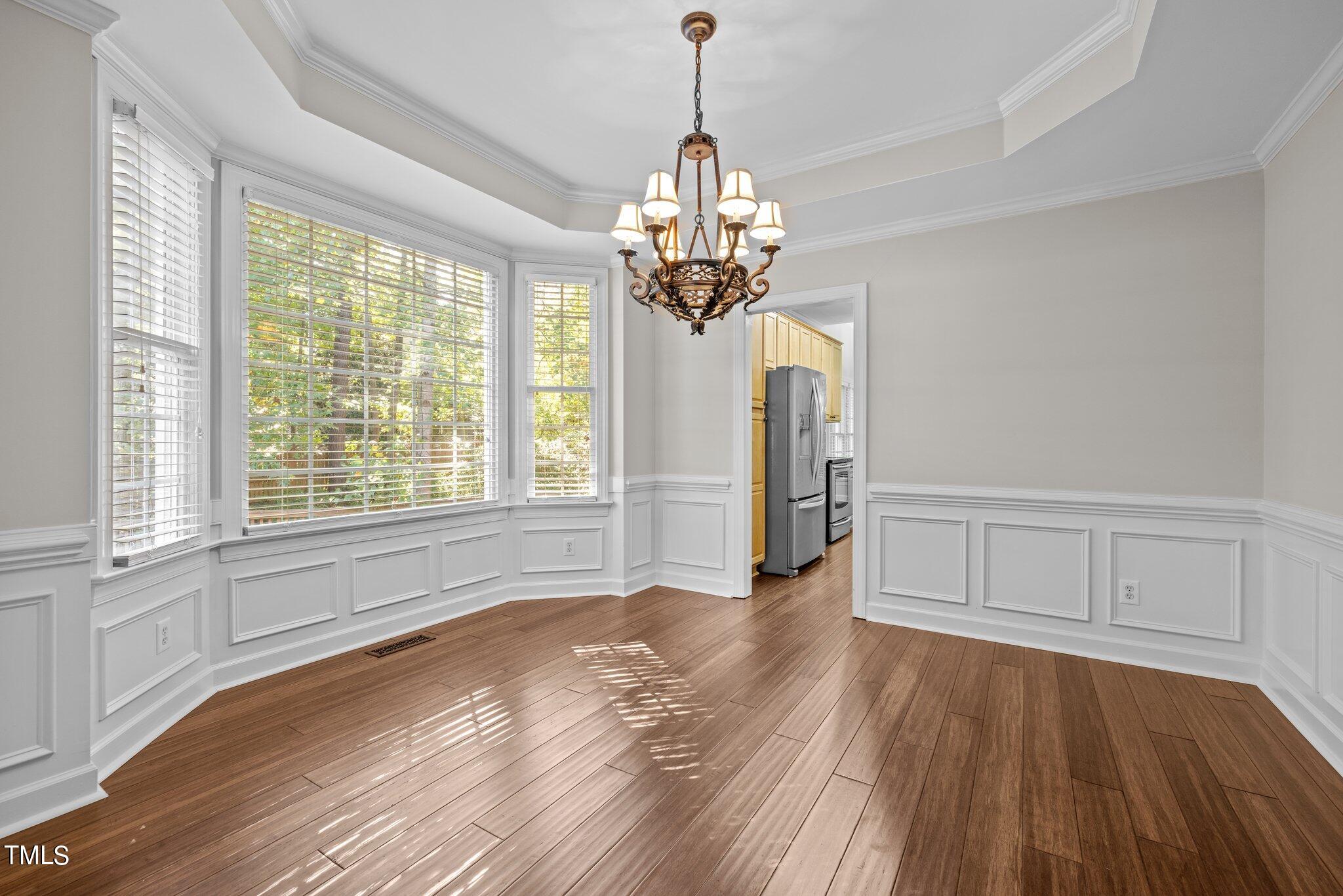 7621 Wilderness Road Raleigh, NC 27613 - Photo 8 of 60 a view of empty room with wooden floor and fan