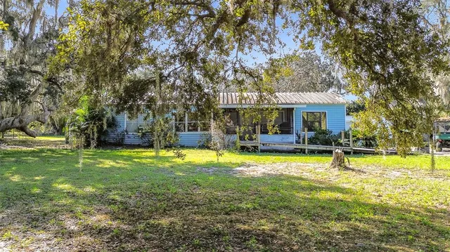 a view of a house with swimming pool and sitting area