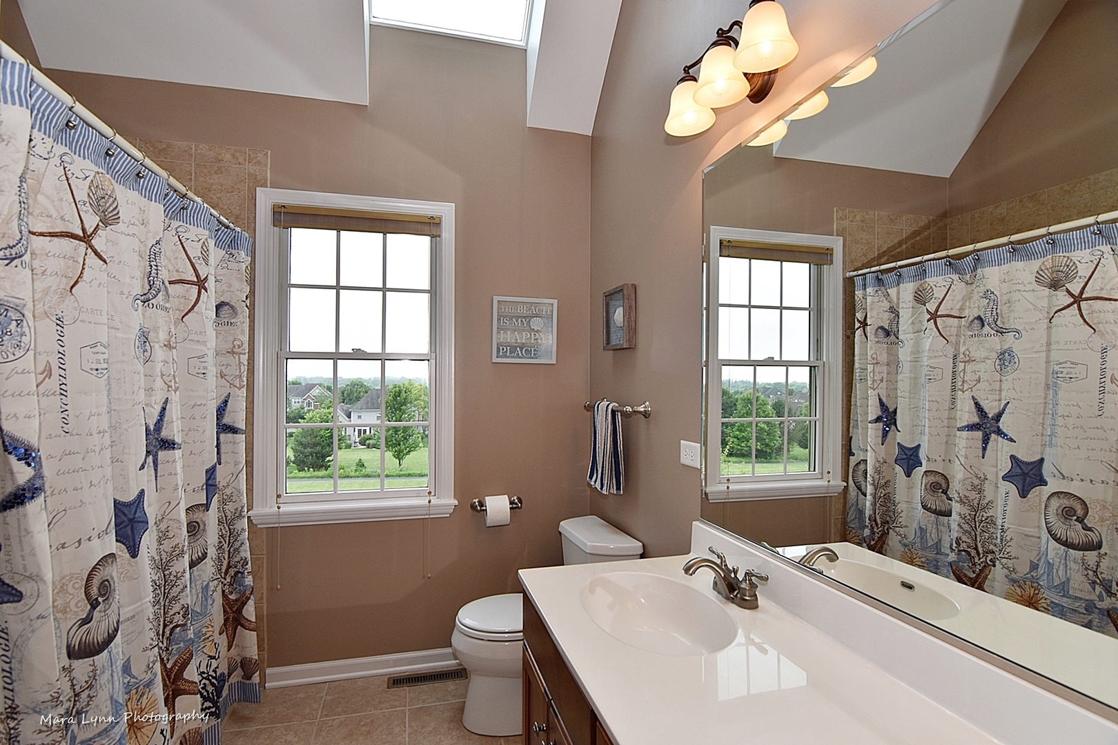 41-w035 Brown Road St. Charles, IL 60175 - Photo 20 of 33 a bathroom with a granite countertop sink a large mirror and a bathtub next to a window