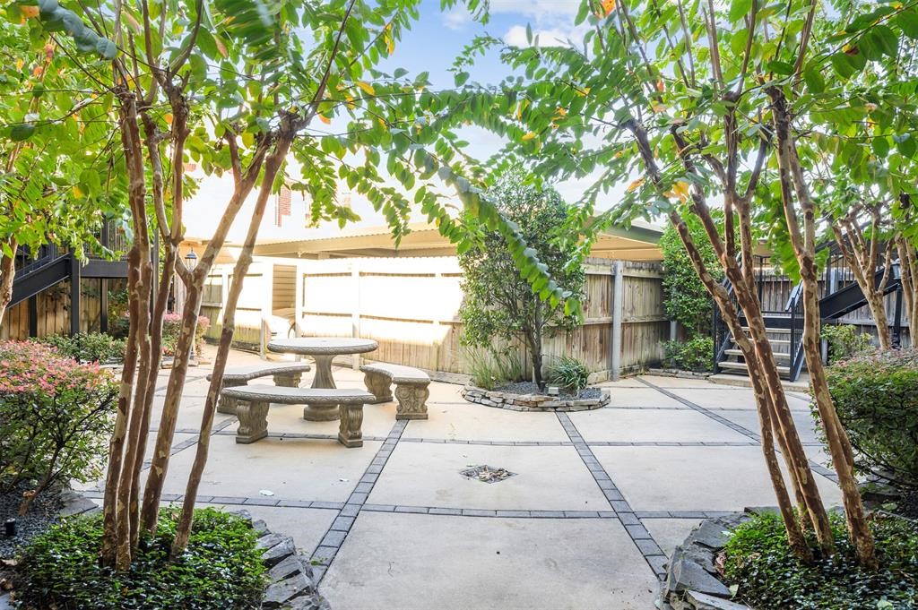 2216 Chenevert Street, Unit 4 Houston, TX 77003 - Photo 21 of 23 a view of a patio with couches and table and chairs and potted plants