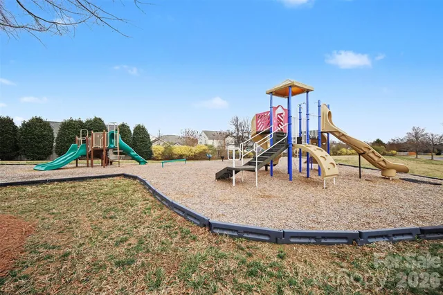 a view of a swimming pool with a yard and sitting space