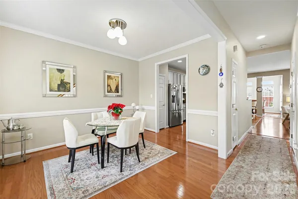 a view of a dining room with furniture and wooden floor