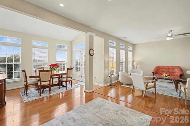 a living room with furniture dining table and a large window