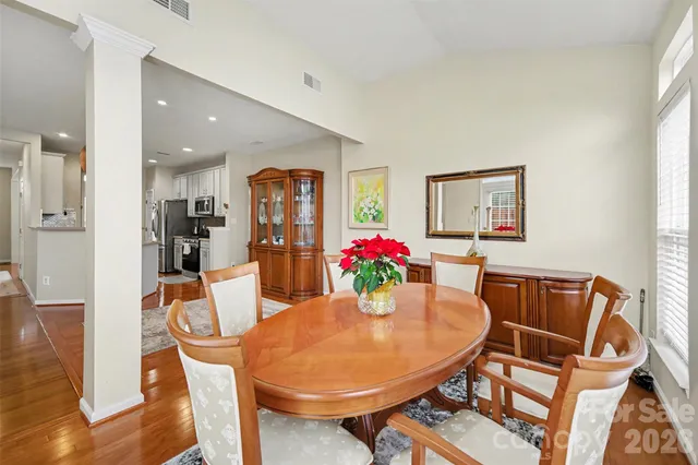 a dining room with furniture and wooden floor