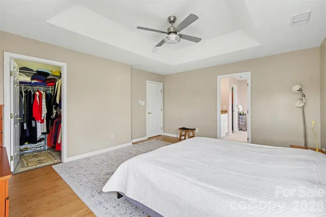 a bedroom with a large bed and a chandelier