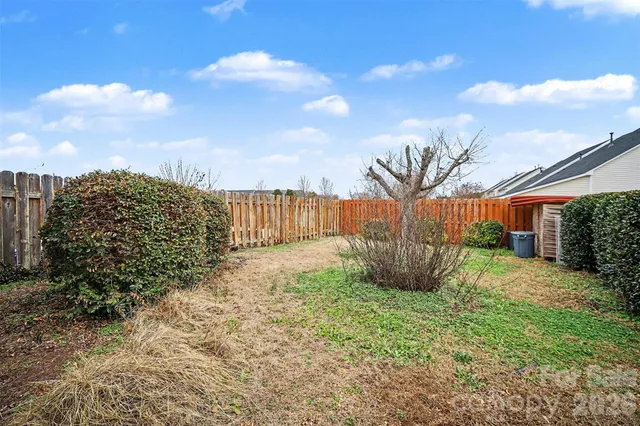 a view of a backyard with pathway