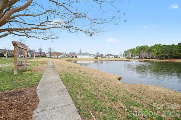 a view of a lake with houses in the back