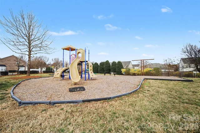 a view of outdoor space with playground and green space