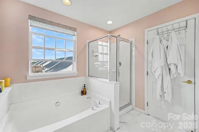 a bathroom with a bathtub and a shower