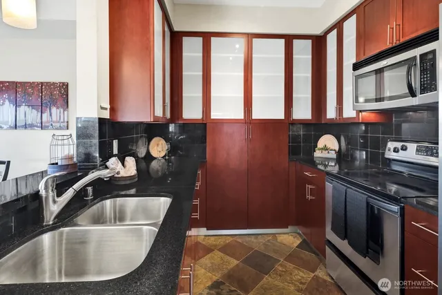 a kitchen with a sink and a large window