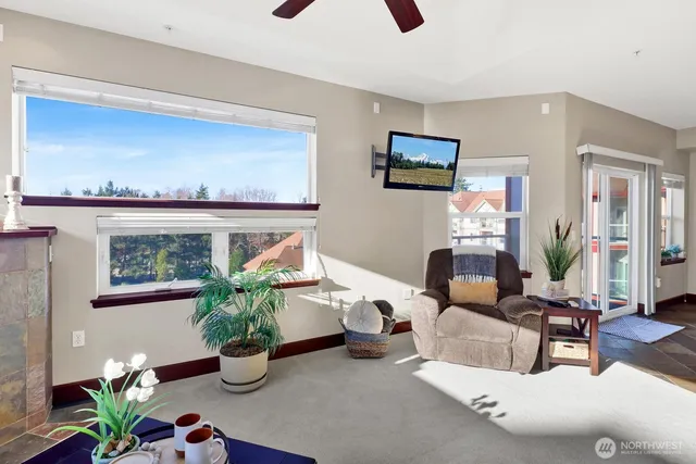 a living room with furniture and a potted plant